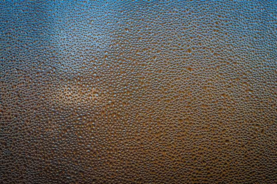 Close-up of vibrant stained glass with condensation droplets, arranged in a hexagonal pattern. Artistic abstract detail. — base photo: An artistic close-up capturing delicate water droplets forming on a vibrant stained glass surface. T