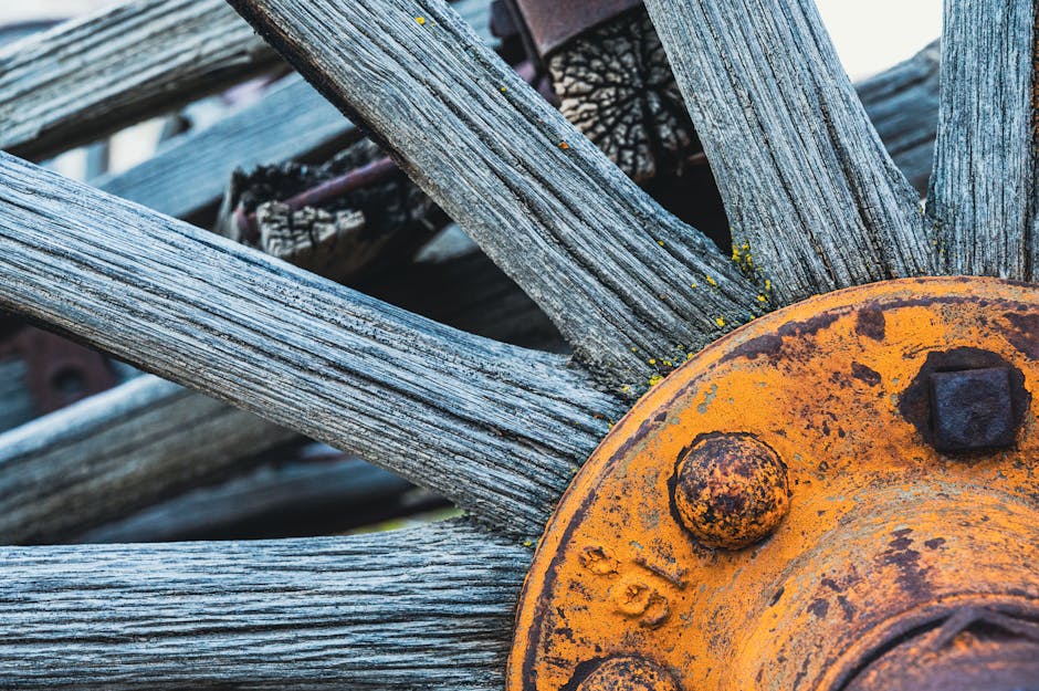 A wallpaper pattern featuring a rotating cipher wheel motif with rotational symmetry, inspired by an antique wooden and metal cipher wheel. — base photo: A close-up view of an antique cipher wheel. The photograph emphasizes the aged texture of the wood a
