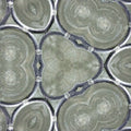Close-up of a Leaded Glass Clusters wallpaper pattern with a hexagonal repeat, showing intricate dark metal solder lines and abstract glass fragments. Inspired by metal drum containers.