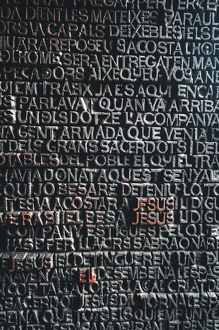 Seamless hex wallpaper pattern — Calligraphy by wallpaper⁶ — base photo: Detailed close-up of intricate Latin script on a famous monument door in Barcelona, Spain.