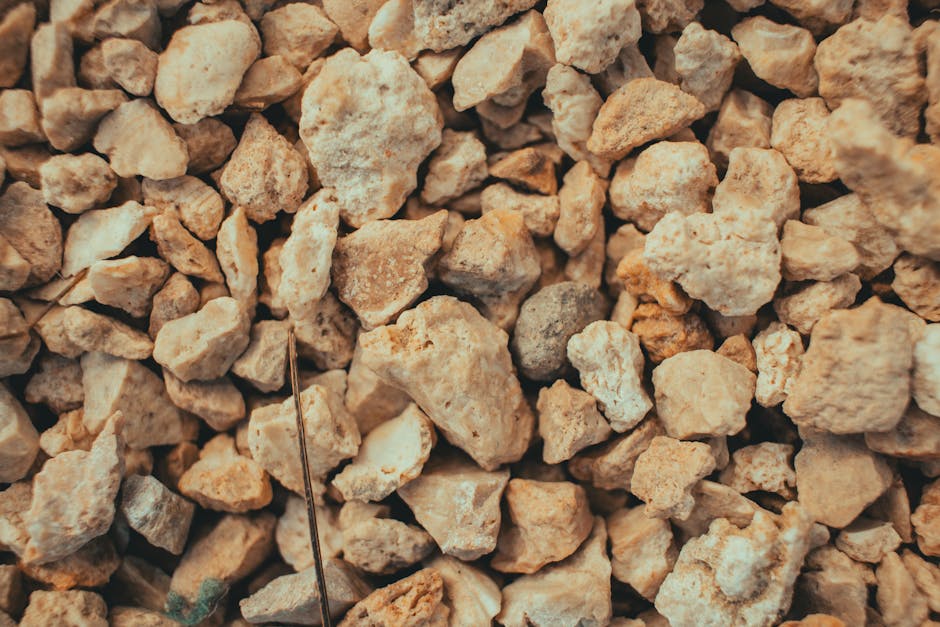 Molecular Physics Kaleidoscope wallpaper pattern — base photo: Detailed close-up of brown gravel and stones, showcasing texture and variety.