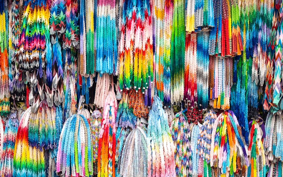 Seamless diamond wallpaper pattern — Origami by wallpaper⁶ — base photo: Vibrant origami cranes in various colors hanging at a market stall showcasing traditional craft.