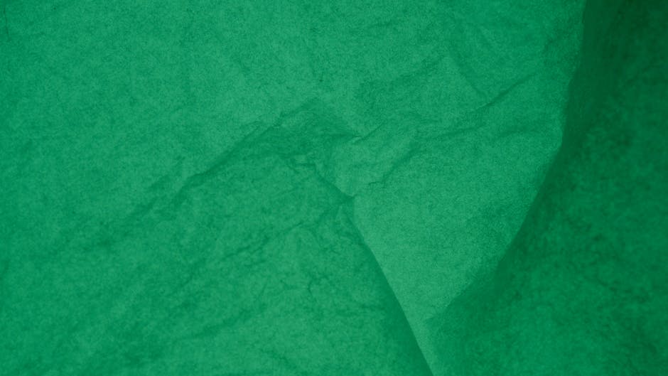 Seamless mirror wallpaper pattern — Origami by wallpaper⁶ — base photo: Detailed view of an emerald green wrinkled paper texture for backgrounds or designs.