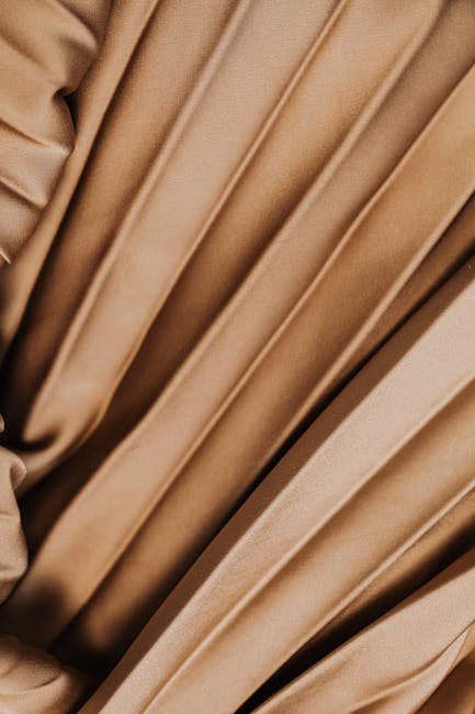 Seamless kaleidoscope wallpaper pattern — Origami by wallpaper⁶ — base photo: Closeup of luxurious beige pleated fabric texture showcasing the elegant velvet finish.