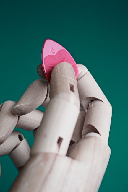 Seamless mirror wallpaper pattern — Glitch by wallpaper⁶ — base photo: Close-up of a wooden mannequin's hand holding a pink guitar pick against a green background.