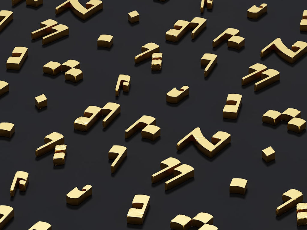 Seamless mirror wallpaper pattern — Arithmetic by wallpaper⁶ — base photo: a group of gold letters and numbers on a black surface