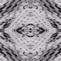 Close-up of textured brown paper in a geometric honeycomb pattern with mirror symmetry, inspired by origami folds.