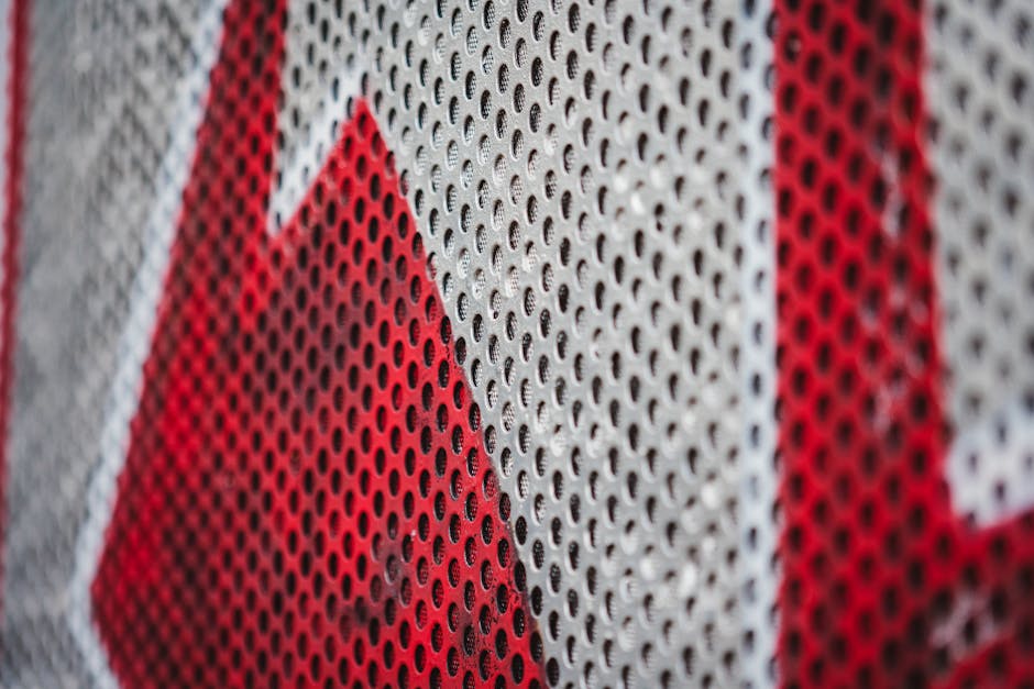Data Vertical Strip wallpaper pattern — base photo: Detailed close-up of a perforated metal sheet painted in striking red and white colors.