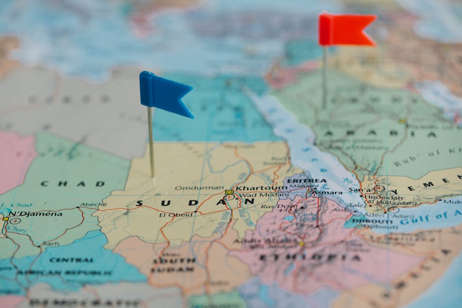 Seamless brick wallpaper pattern — Cartography by wallpaper⁶ — base photo: Detailed close-up map of Africa featuring Sudan and nearby countries marked with flags.