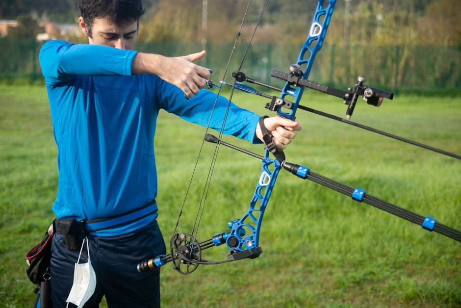 Seamless mirror wallpaper pattern — Biochemistry by wallpaper⁶ — base photo: Adult man in blue long sleeves practicing archery outdoors with a compound bow in a grassy field.