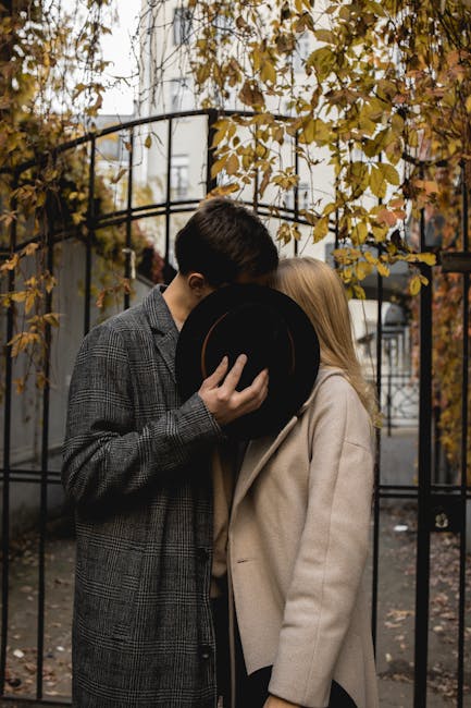 Cryptography Rotation wallpaper pattern — base photo: A stylish couple shares an intimate moment in a fall park, elegantly dressed in coats, partially obs
