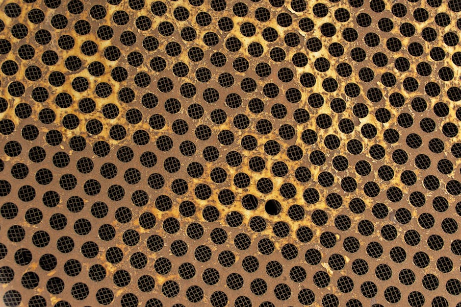 Molecular Physics Diamond wallpaper pattern — base photo: Close-up of a rusted honeycomb metal pattern with circular perforations.
