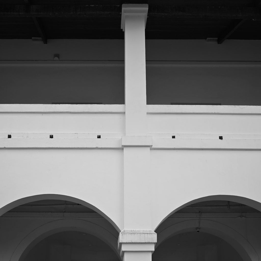 WALLPAPER⁶ — seamless rotate4 pattern from bauhaus architecture detail, Bauhaus — base photo: Building's interior features arches and a vertical column.