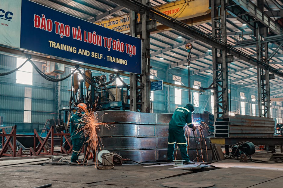 Seamless kaleidoscope wallpaper pattern — Biochemistry by wallpaper⁶ — base photo: Workers weld metal structures in a bustling industrial factory, showcasing a dynamic work environmen