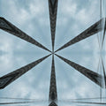 A radial kaleidoscope pattern of white steeples and golden crosses forming a blue stained glass geometric design.