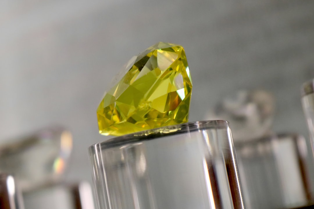 Mineralogy Hexagon wallpaper pattern — base photo: a yellow diamond sitting on top of a glass block