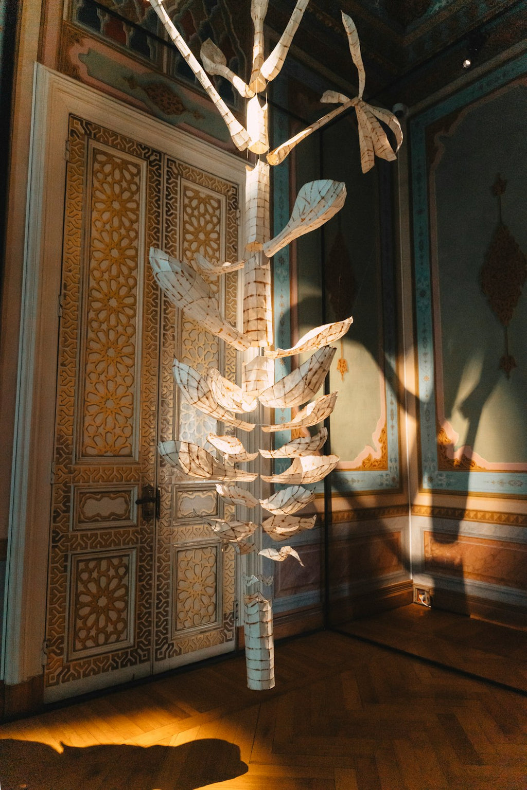 Seamless kaleidoscope wallpaper pattern — Origami by wallpaper⁶ — base photo: An ornate door with a hanging paper sculpture.