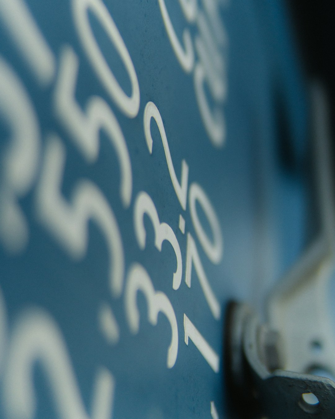 Seamless mirror wallpaper pattern — Arithmetic by wallpaper⁶ — base photo: Capturing the essence of detail, this photograph showcases a striking close-up of embossed numbers o