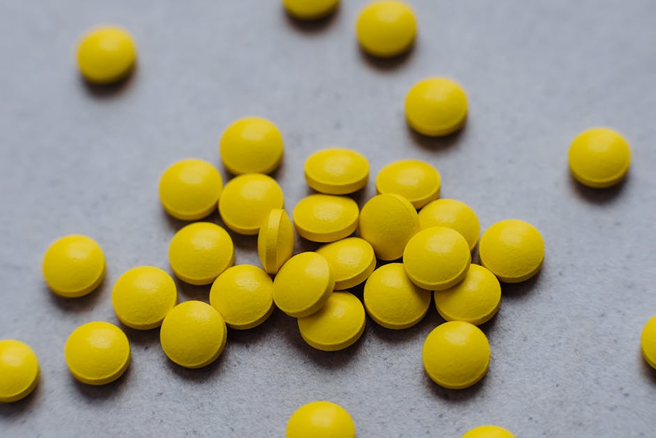 Seamless kaleidoscope wallpaper pattern — Biochemistry by wallpaper⁶ — base photo: A collection of bright yellow pills scattered on a gray surface, ideal for health and wellness theme