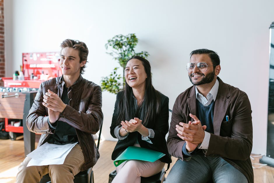 Seamless hex wallpaper pattern — Arithmetic by wallpaper⁶ — base photo: Three diverse team members clapping and smiling during an indoor meeting, showing positivity and tea