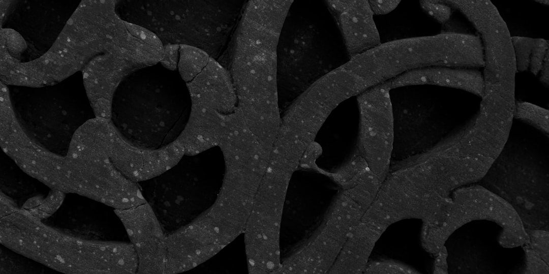 Seamless kaleidoscope wallpaper pattern — Calligraphy by wallpaper⁶ — base photo: An experimental photo an intricate stone lattice with geometric cutouts at Qutb Minar. The carved pa