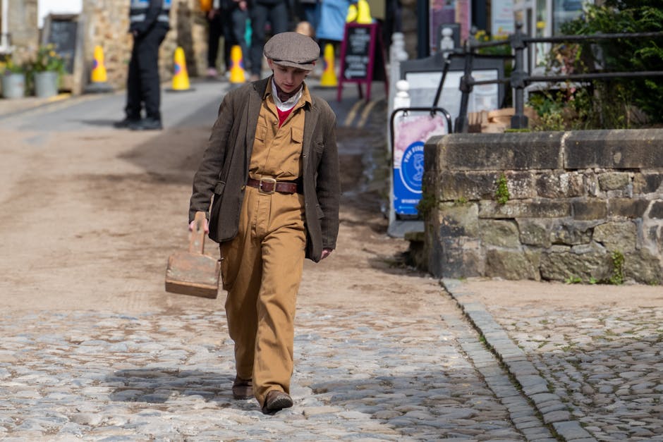 Statistics Hexagon wallpaper pattern — base photo: A young boy in vintage attire walks down a cobblestone street in Grassington, England.