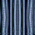 Abstract wallpaper pattern inspired by wet folding origami, featuring dark, vertically arranged elements with a mirror symmetry repeat. From Monstera Production.