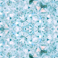 Close-up of shattered turquoise opalescent glass pieces arranged in a repeating hex symmetrical pattern on wallpaper.