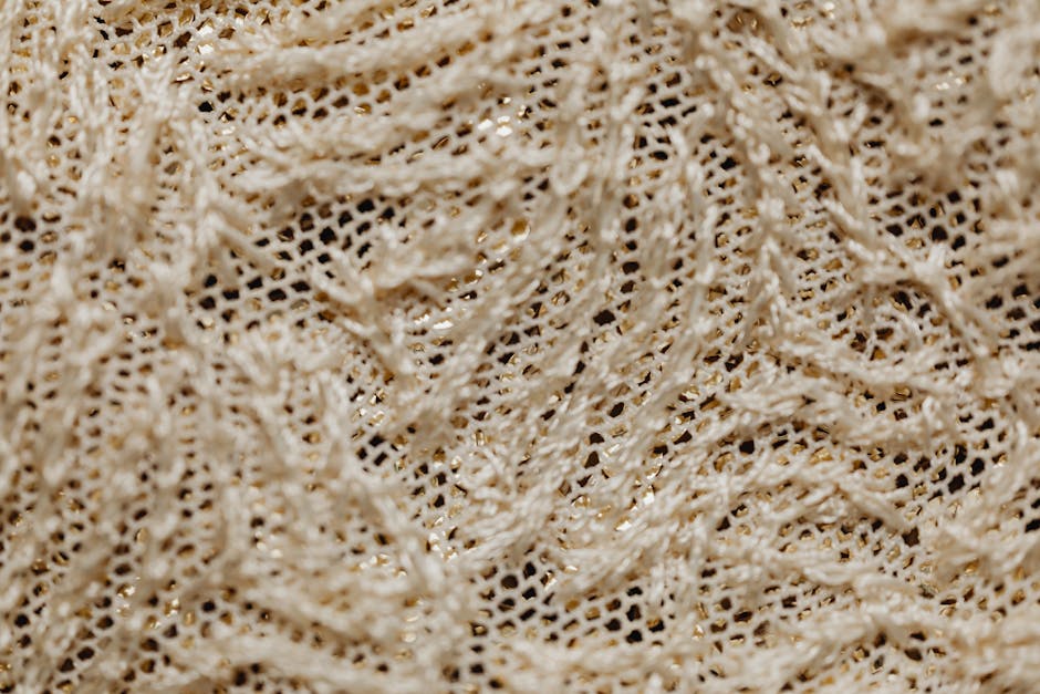 Topology Kaleidoscope wallpaper pattern — base photo: Close-up view of intricately woven beige lace fabric showcasing texture and pattern.