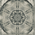 A seamless monochrome wallpaper pattern featuring kaleidoscopic reflections of a rocky mountain side with sharp contrast.