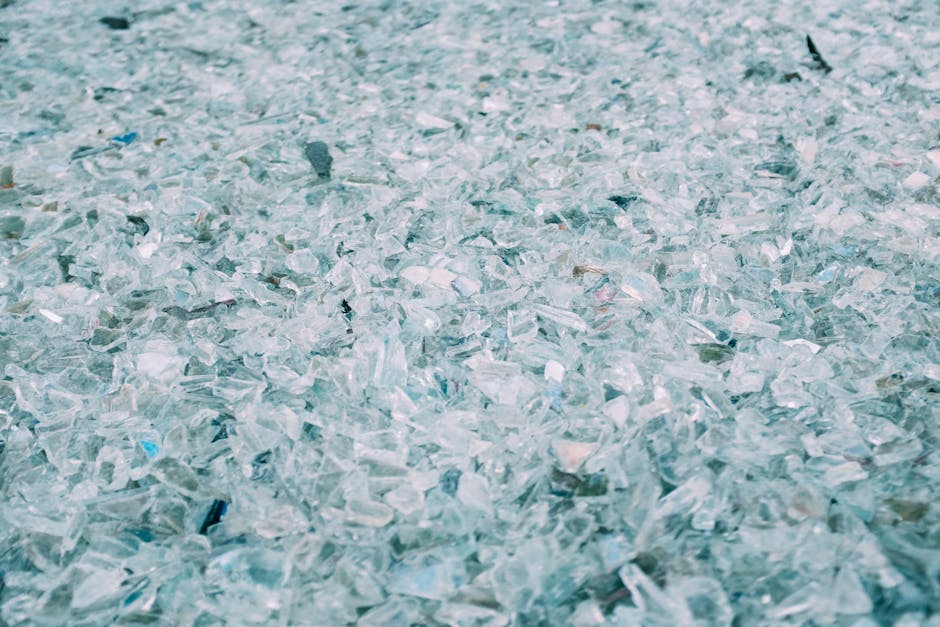 Close-up of shattered turquoise opalescent glass pieces arranged in a repeating hex symmetrical pattern on wallpaper. — base photo: A high-detail close-up of scattered, shattered turquoise glass pieces. The soft focus blurs the edge