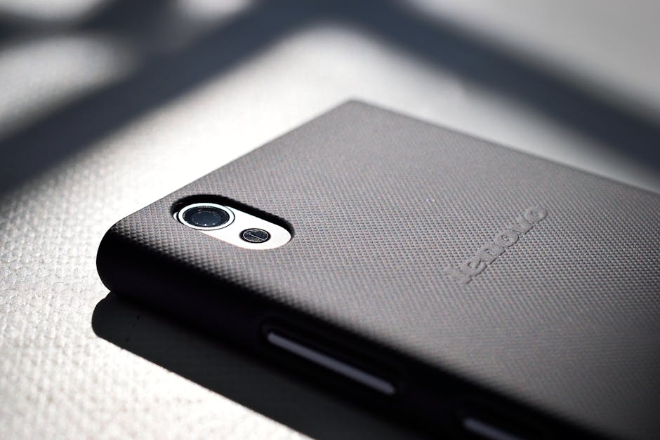 Seamless pinwheel wallpaper pattern — Cosmology by wallpaper⁶ — base photo: Detailed close-up view of a smartphone with a textured back cover emphasizing modern design and tech