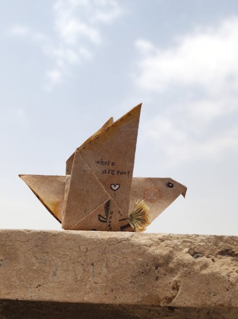 Seamless mirror wallpaper pattern — Origami by wallpaper⁶ — base photo: Paper origami bird with creative doodles on a stone ledge under a bright sky.