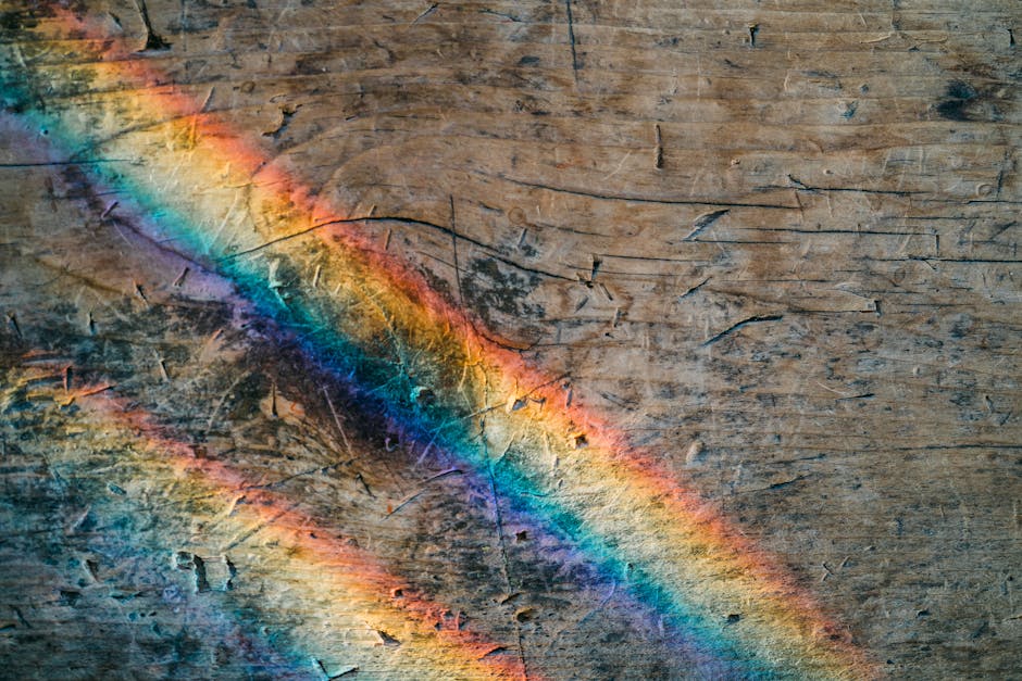 Seamless mirror wallpaper pattern — Glitch by wallpaper⁶ — base photo: A colorful rainbow reflection on a textured wooden surface, creating a captivating abstract pattern.