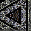 Gothic Rose pattern with hexagonal symmetry, inspired by stained glass windows, in shades of blue, red, and yellow.