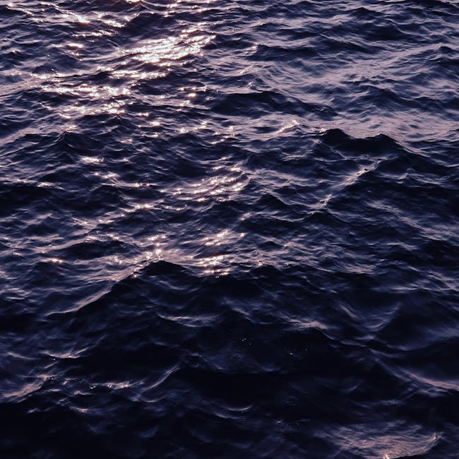 A sophisticated hexagonal repeat pattern of deep blue ocean water and white sea foam with Hex symmetry. — base photo: A high-resolution top-down perspective of turbulent ocean water, showcasing varied depths, sunlight 