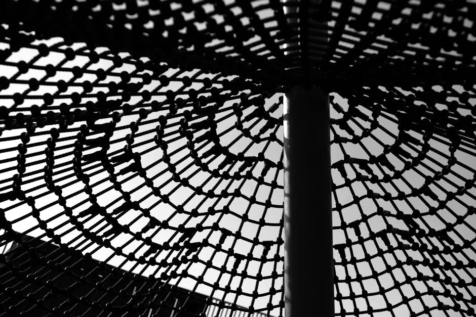 Seamless kaleidoscope wallpaper pattern — Geometry by wallpaper⁶ — base photo: Captivating black and white abstract image of a geometric net structure casting intricate shadows.