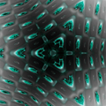 A complex geometric pattern of grey and black squares arranged in a seamless hexagonal Hex symmetry.