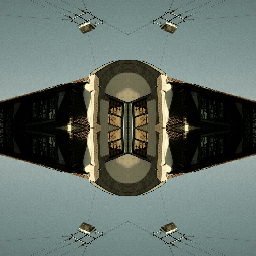 A seamless wallpaper pattern featuring red, yellow, and blue geometric shapes reflected in a four-way Mirror symmetry design.