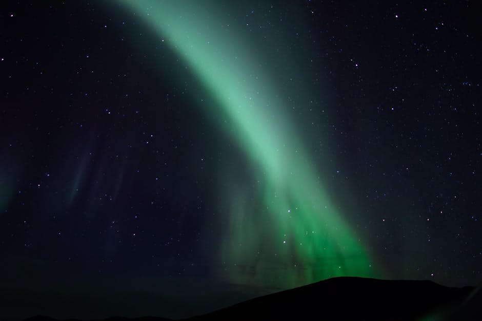 Seamless mirror wallpaper pattern — Astronomy by wallpaper⁶ — base photo: Breathtaking view of the aurora borealis illuminating the night sky filled with stars.