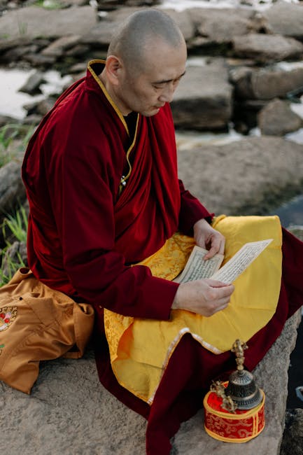 Seamless hex wallpaper pattern — Calligraphy by wallpaper⁶ — base photo: A Buddhist monk in a red robe reads by the river, with ritual items nearby, in a peaceful outdoor se