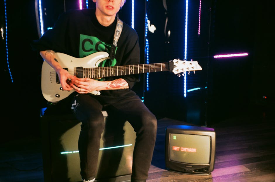 Seamless mirror wallpaper pattern — Glitch by wallpaper⁶ — base photo: Crop young male musician in casual wear sitting on floor speaker with modern bass guitar during rehe