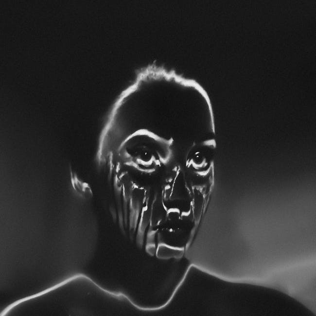 A monochromatic Rorschach-style mirror pattern created from a human portrait with high-contrast shadows and highlights. — base photo: A moody, high-contrast black and white portrait of a person with eyes closed, capturing subtle textu