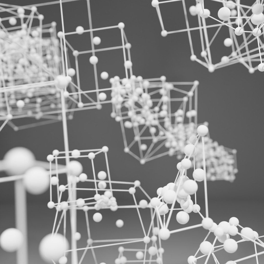A dark, monochromatic wallpaper pattern showing a radial Kaleidoscope symmetry of 3D geometric prisms and sharp shards. — base photo: A high-resolution 3D digital render featuring monochromatic dark grey and black geometric prisms wit
