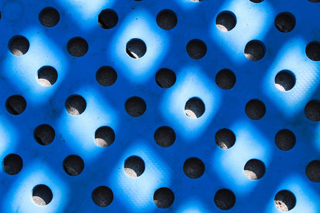 Seamless kaleidoscope wallpaper pattern — Medicine by wallpaper⁶ — base photo: a blue perfored surface with holes in it