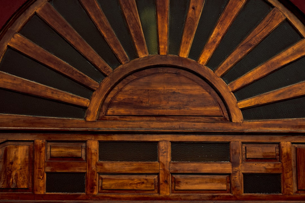Ornate Stained Glass pattern with kaleidoscope symmetry, featuring a wooden sunburst design on a dark background in vibrant jewel tones. — base photo: A wooden sunburst design with a dark, rich background, highlighting the intricate patterns and vibra