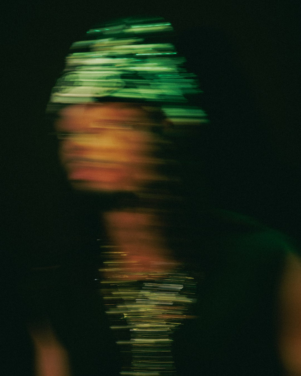 Seamless mirror wallpaper pattern — Glitch by wallpaper⁶ — base photo: A blurred portrait of a person in low light.