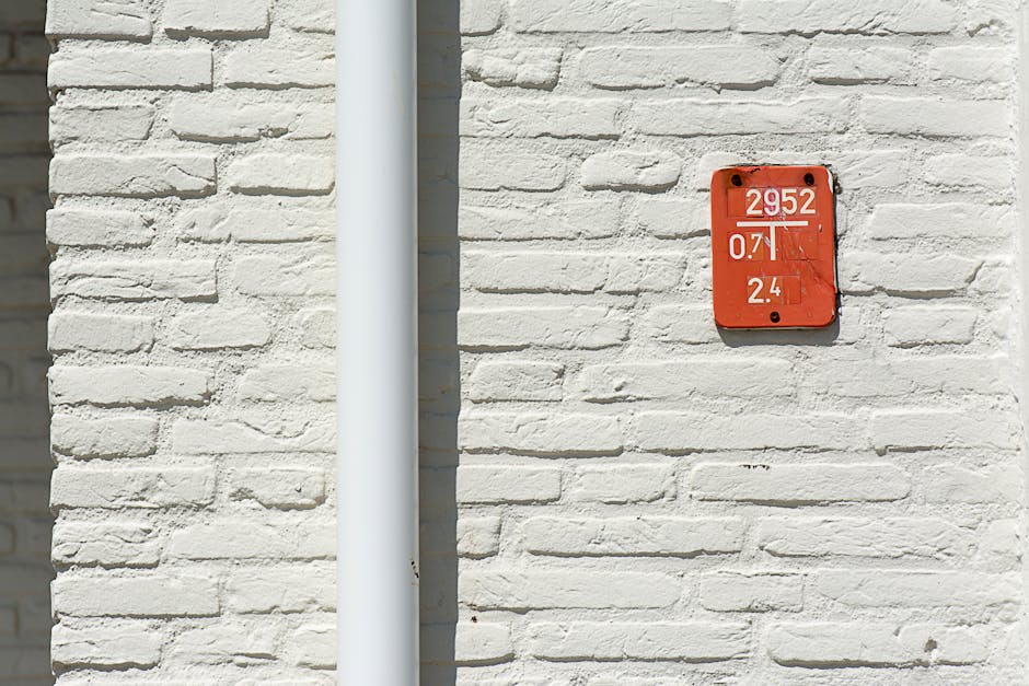 Seamless hex wallpaper pattern — Arithmetic by wallpaper⁶ — base photo: Close-up of a white brick wall featuring a red numbered sign with a white gutter pipe.