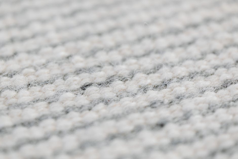 Seamless diamond wallpaper pattern — Glitch by wallpaper⁶ — base photo: Close-up view of a grey handmade woolen rug texture showing detailed weave.