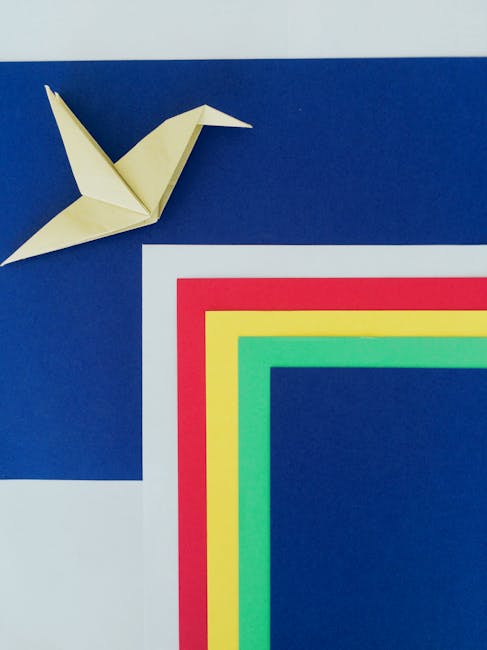 Seamless mirror wallpaper pattern — Origami by wallpaper⁶ — base photo: Aerial view of an origami bird on colorful geometric paper background, symbolizing creativity and fr